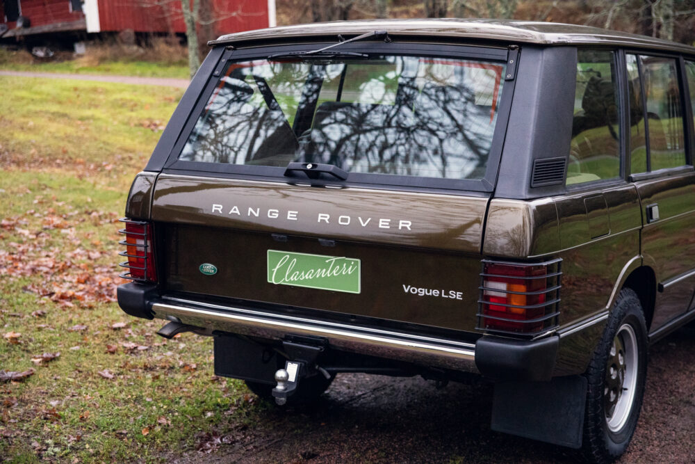 Vintage Range Rover parked outdoors near autumn foliage
