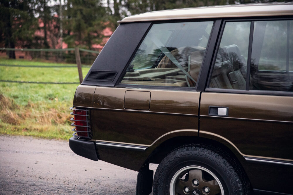 Brown SUV parked near green field