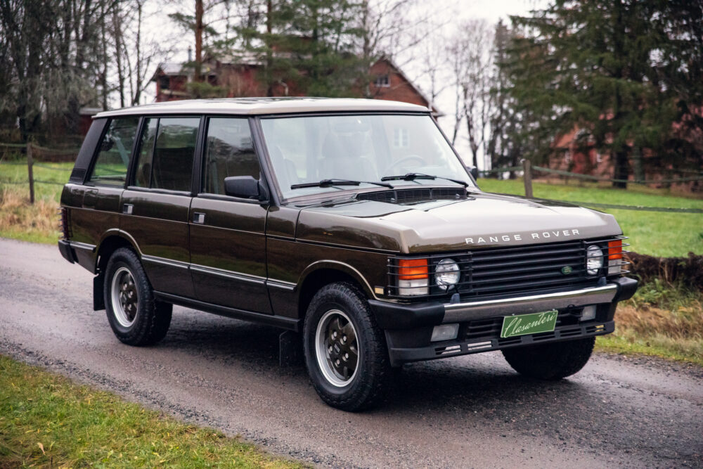 Vintage brown Range Rover parked on a rural road