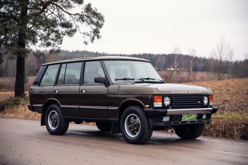 Vintage brown Range Rover parked on a rural road