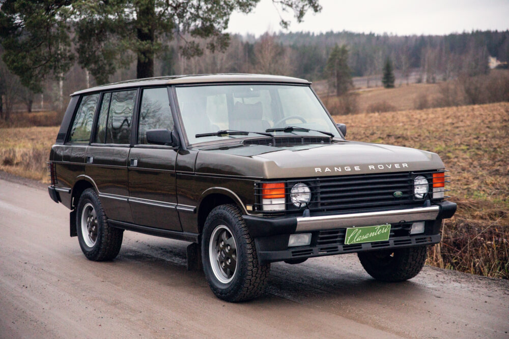 Vintage Range Rover parked on country road