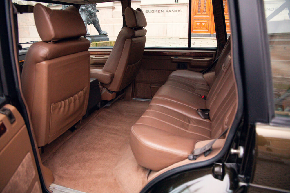 Luxurious tan leather car interior with open door