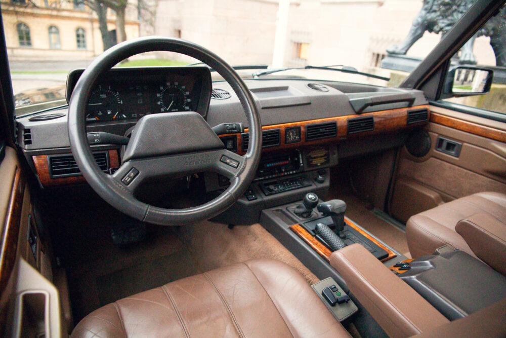 Vintage car interior with leather seats and wooden dashboard