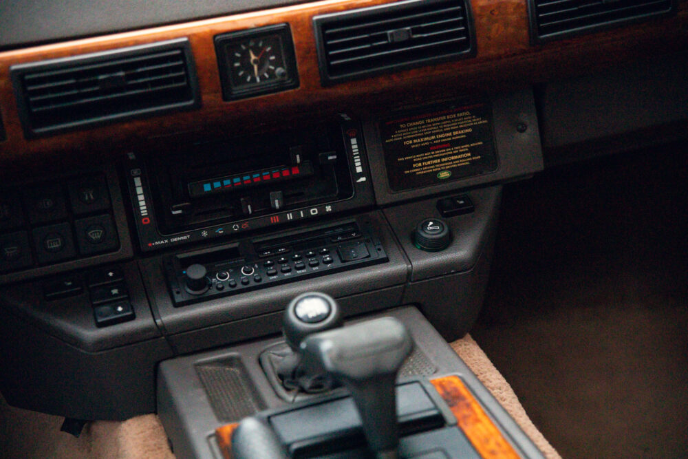 Vintage car dashboard with wooden accents and gear shift