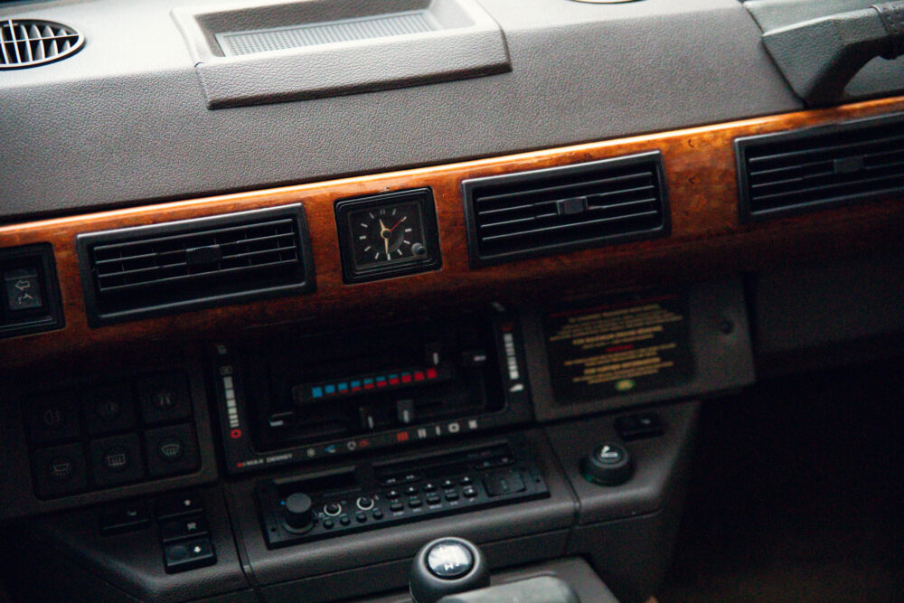 Vintage car dashboard with wooden panel and controls