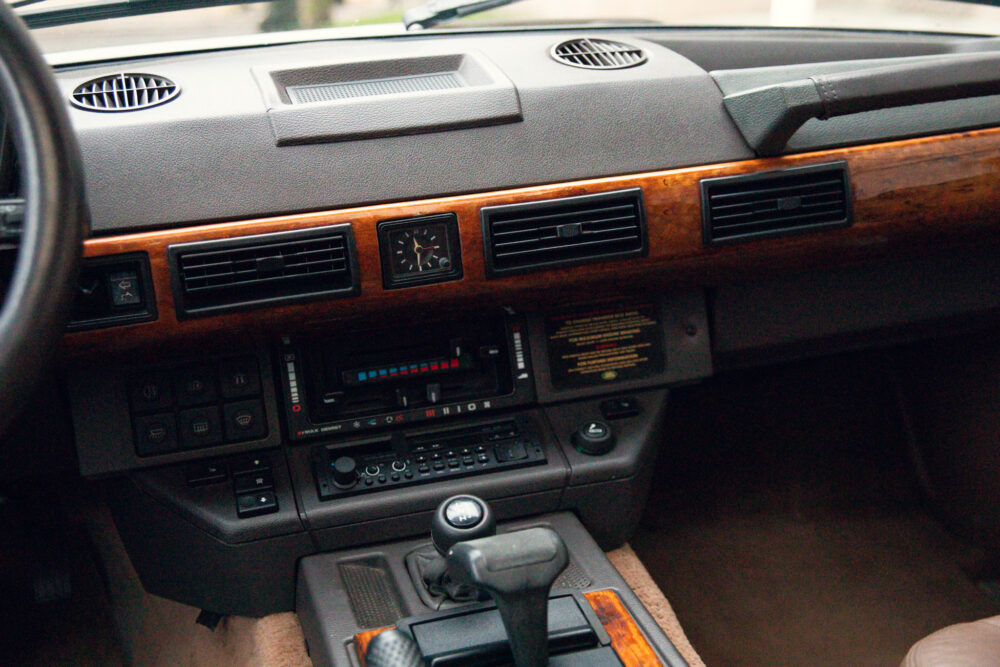 Vintage car dashboard with wooden accents and controls