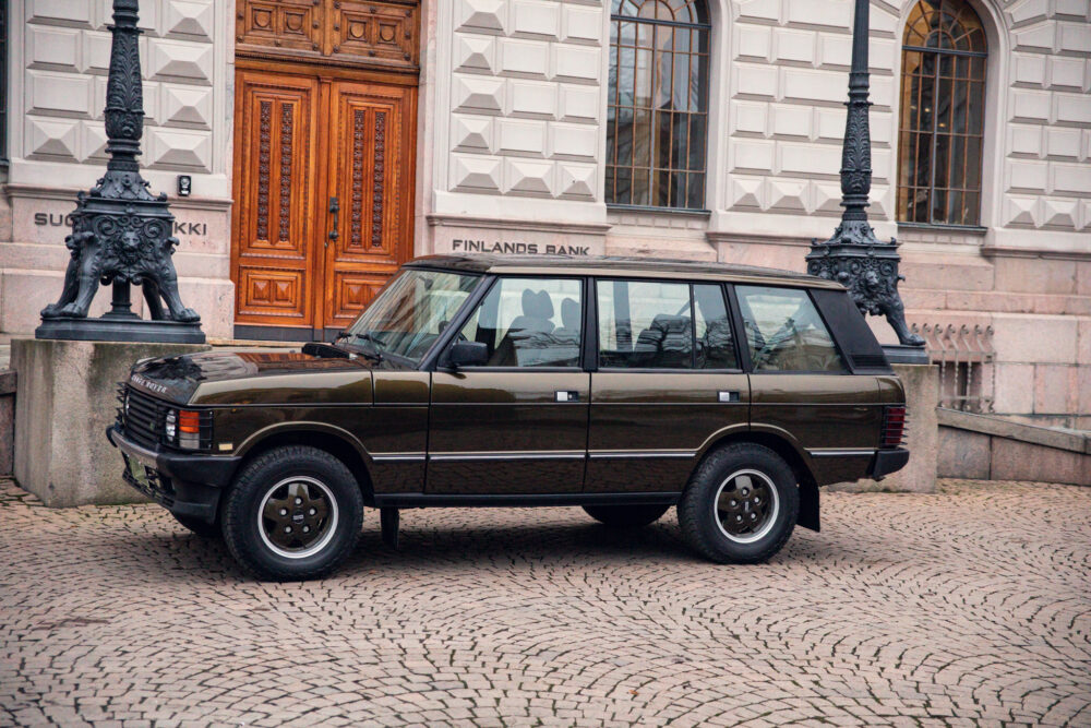 Vintage car parked outside an ornate bank building