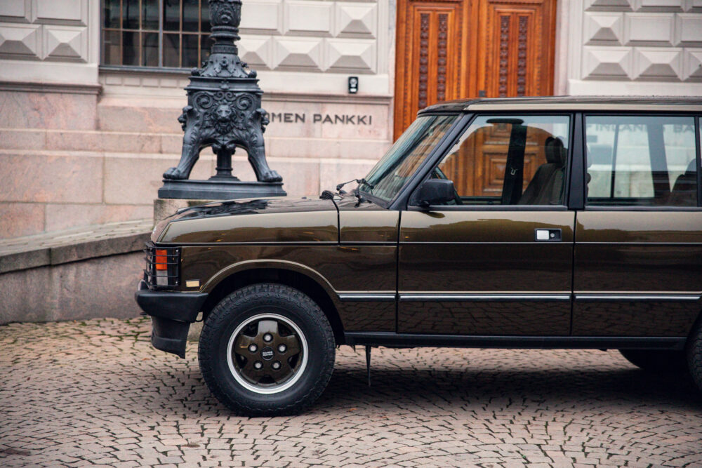 Vintage brown SUV parked near ornate lamp post