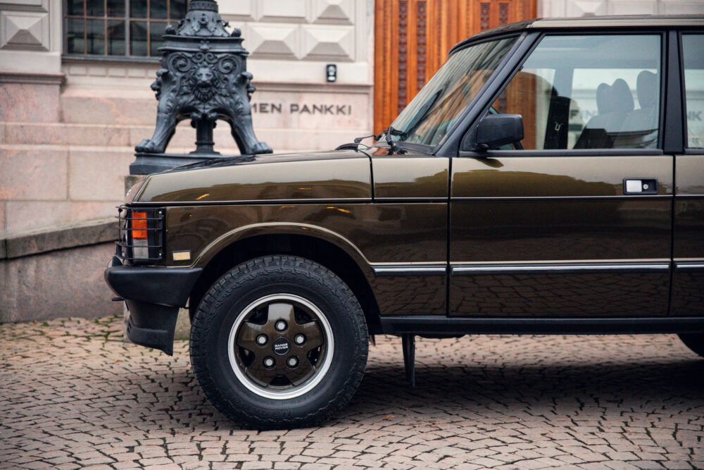 Vintage brown SUV parked near ornate black street lamp