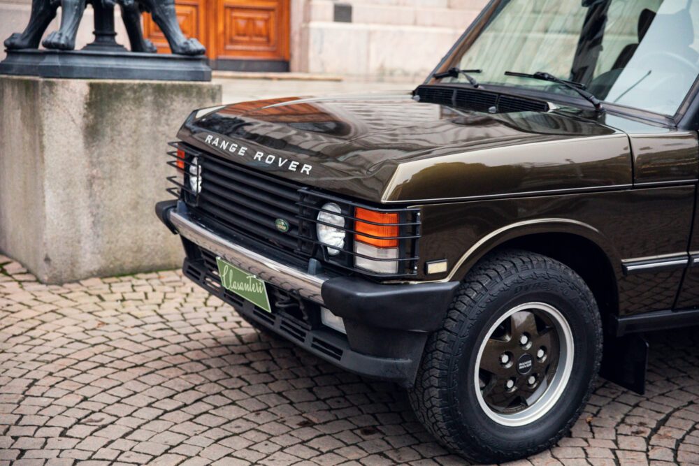 Vintage Range Rover parked near historic building