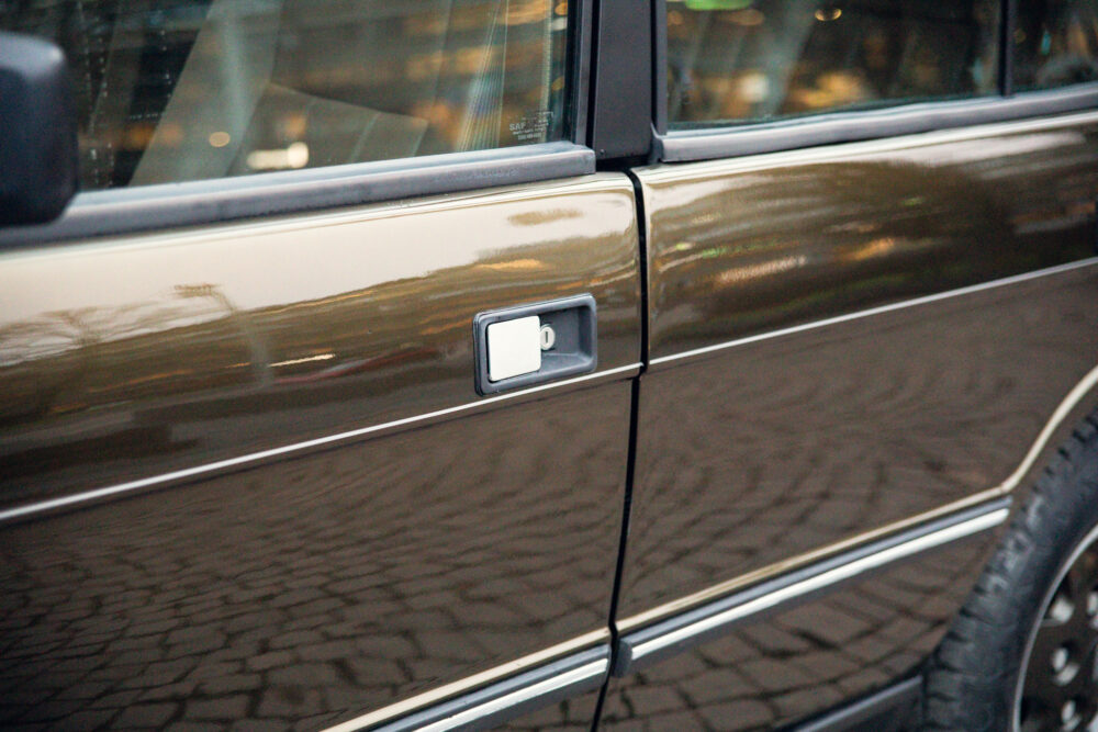 Close-up of car door and handle reflection