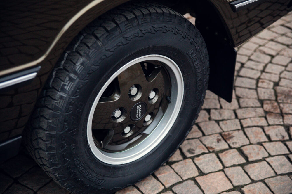 Close-up of Range Rover wheel and tire on cobblestone
