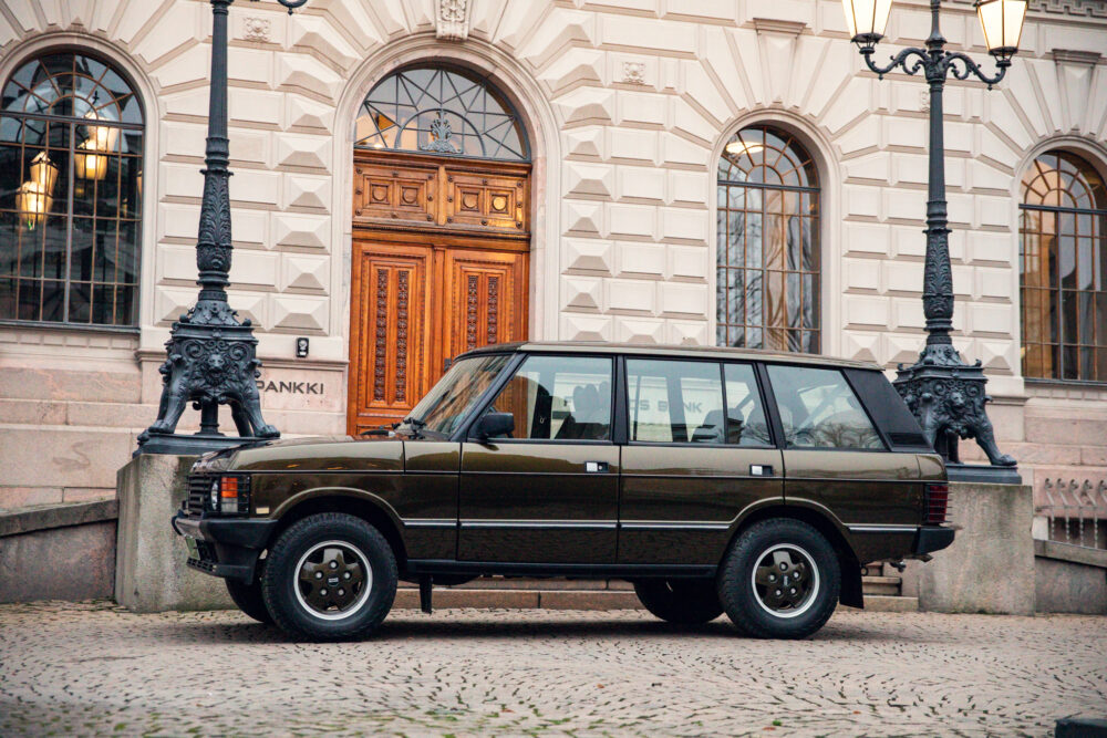 Vintage car parked outside an ornate building