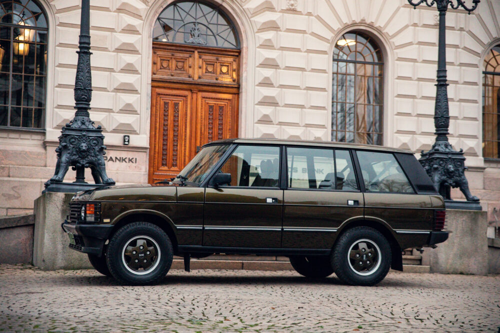 Vintage SUV parked in front of an ornate building