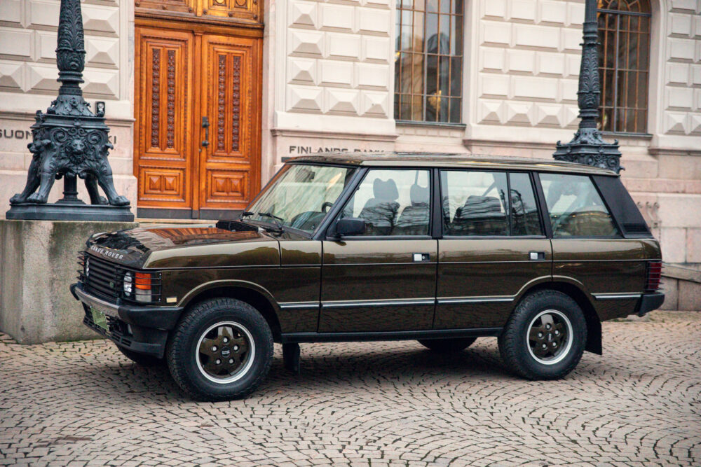 Classic Range Rover parked near ornate building entrance