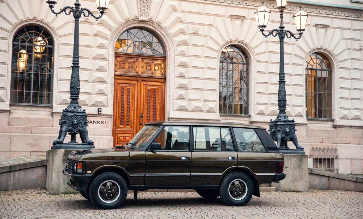 Vintage car parked outside a classical European building