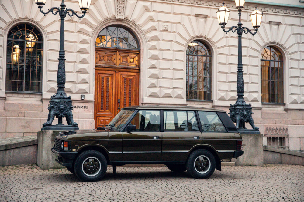 Vintage car parked outside an ornate building