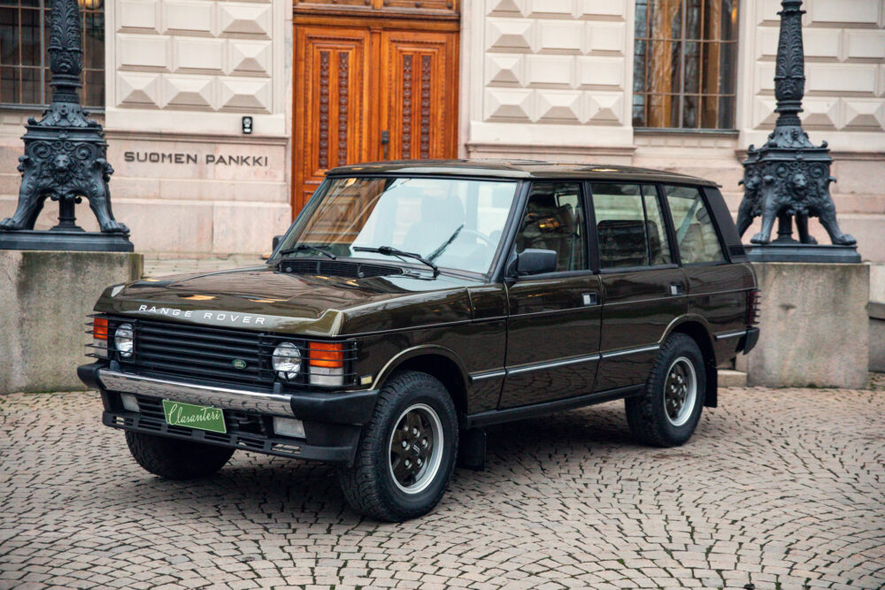 Vintage Range Rover parked near historical building