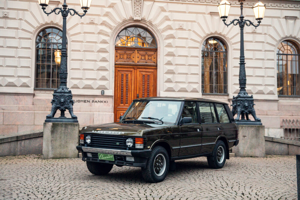 Vintage Range Rover parked outside a classic building