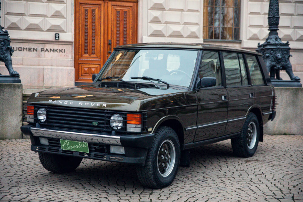 Vintage Range Rover parked in front of elegant building