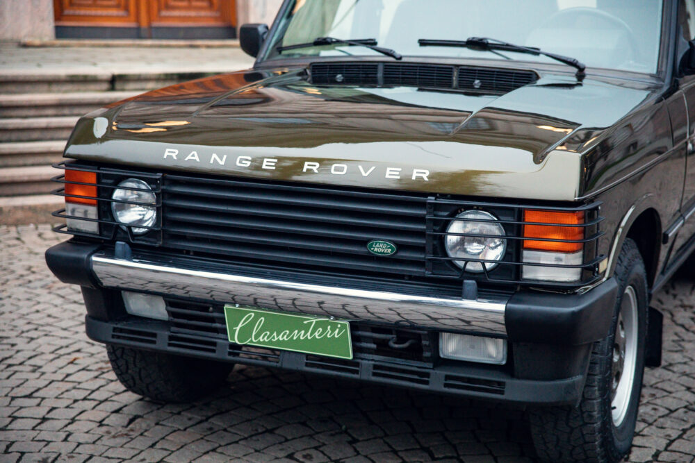 Vintage black Range Rover parked on cobblestone street