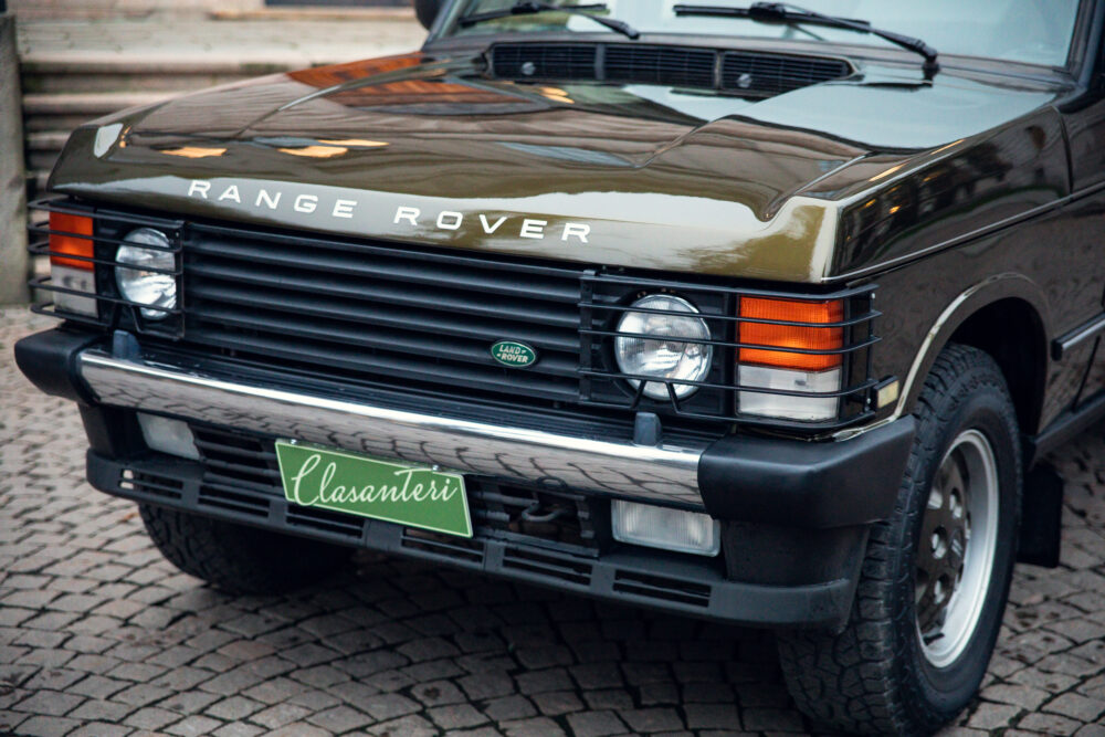 Vintage Range Rover parked on cobblestone street