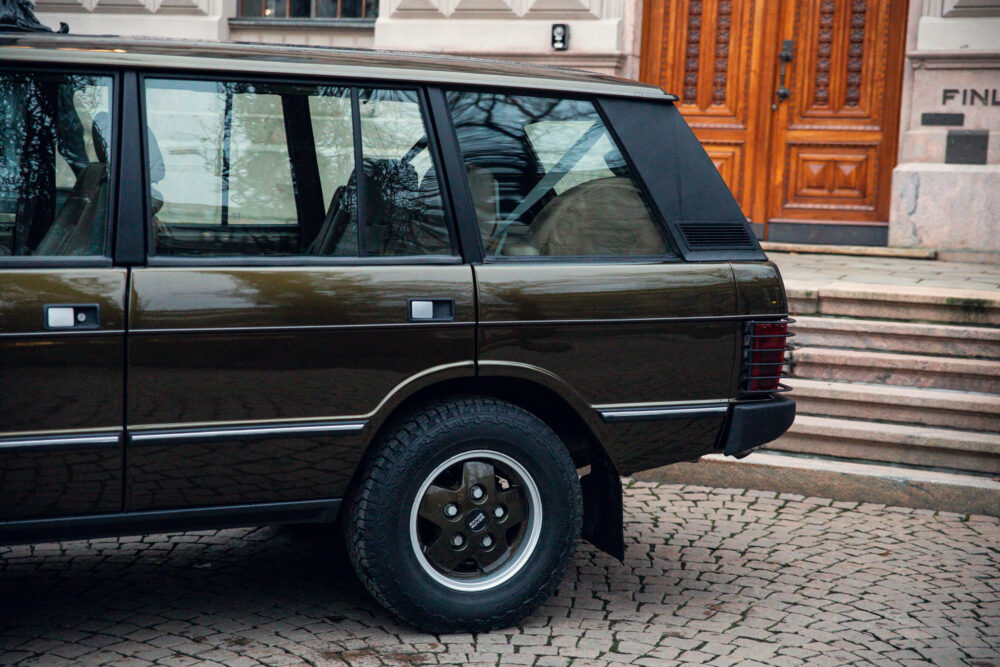 Vintage brown station wagon parked near stone steps