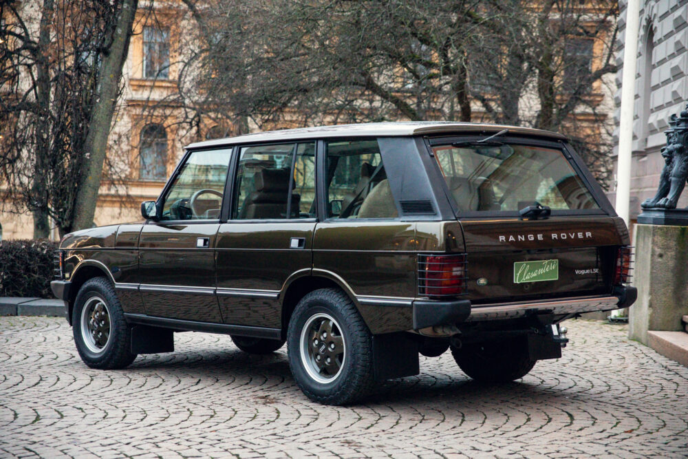 Vintage Range Rover parked on cobblestone street