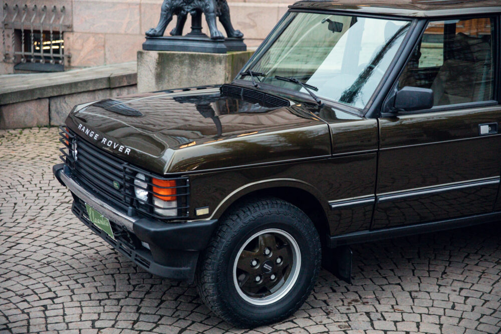 Vintage Range Rover parked on cobblestone street