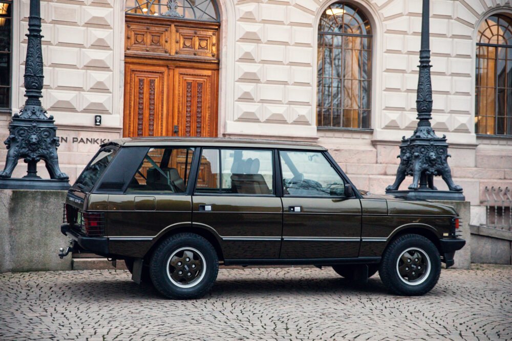 Vintage car parked in front of ornate building