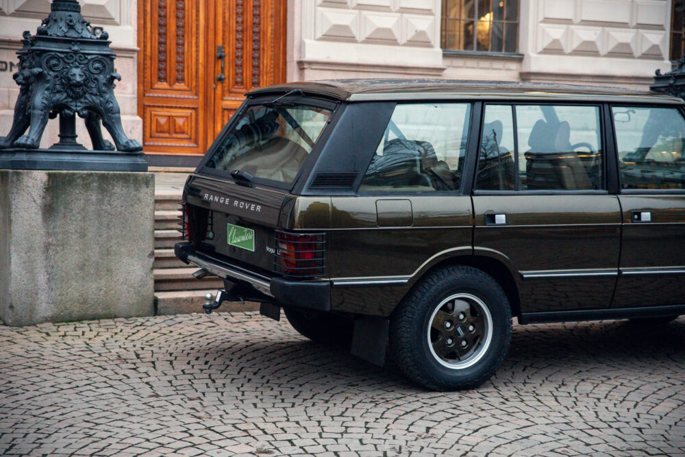 Vintage Range Rover parked near ornate building entrance