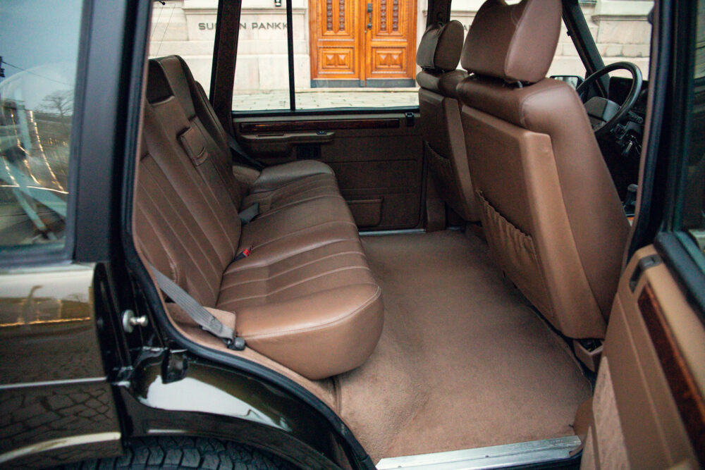 Open car door showing spacious brown leather interior