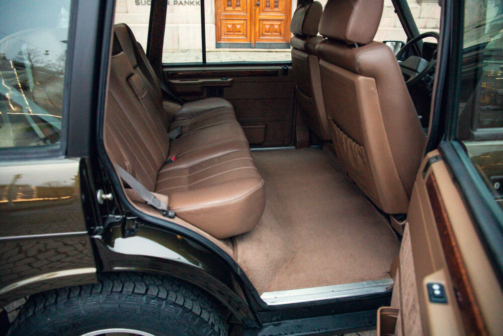 Open SUV door showing spacious brown interior