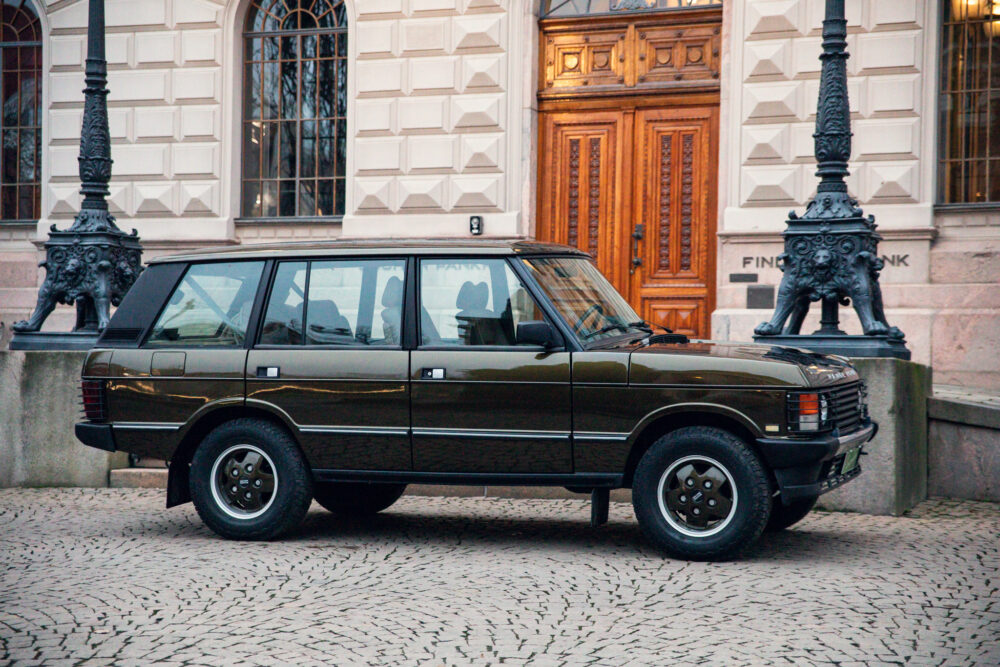 Vintage SUV parked near ornate building entrance
