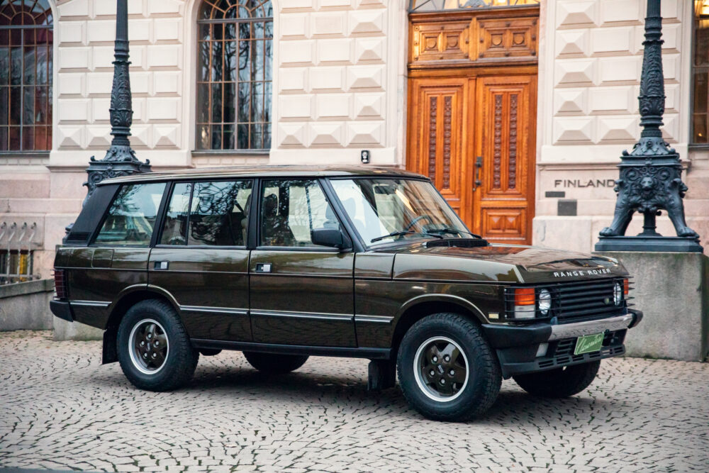 Vintage Range Rover parked near ornate building entrance