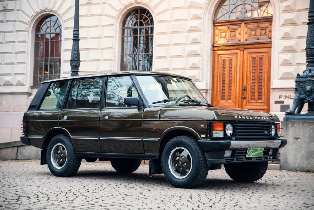 Vintage Range Rover parked outside elegant building
