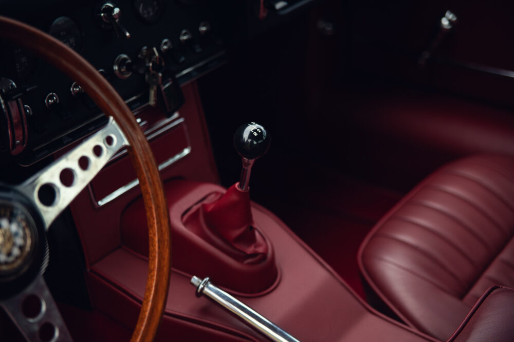 Vintage car interior with red leather seats and dashboard