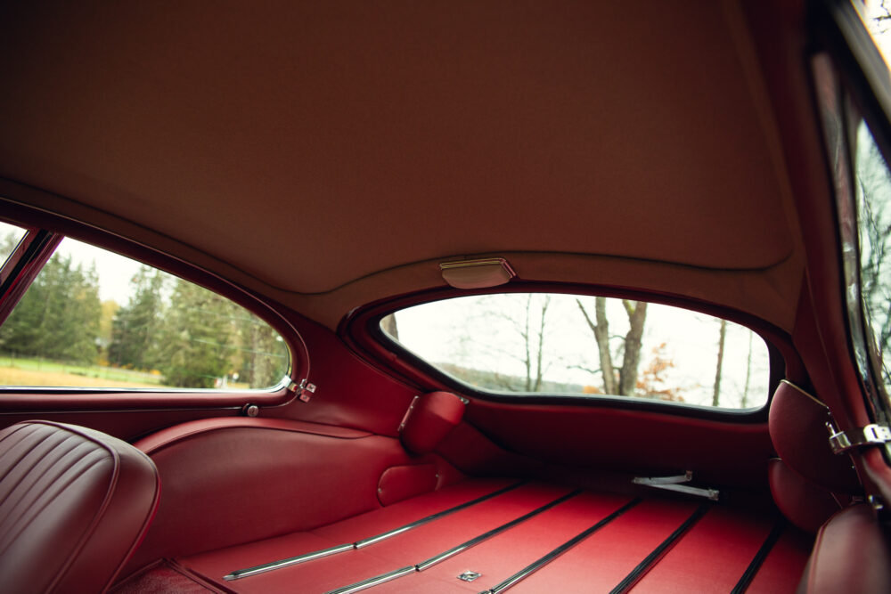 Vintage car interior with red leather seats and view