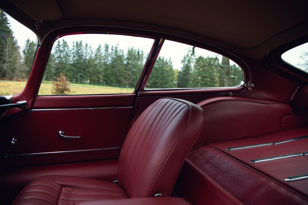 Vintage car red interior with view of pine trees