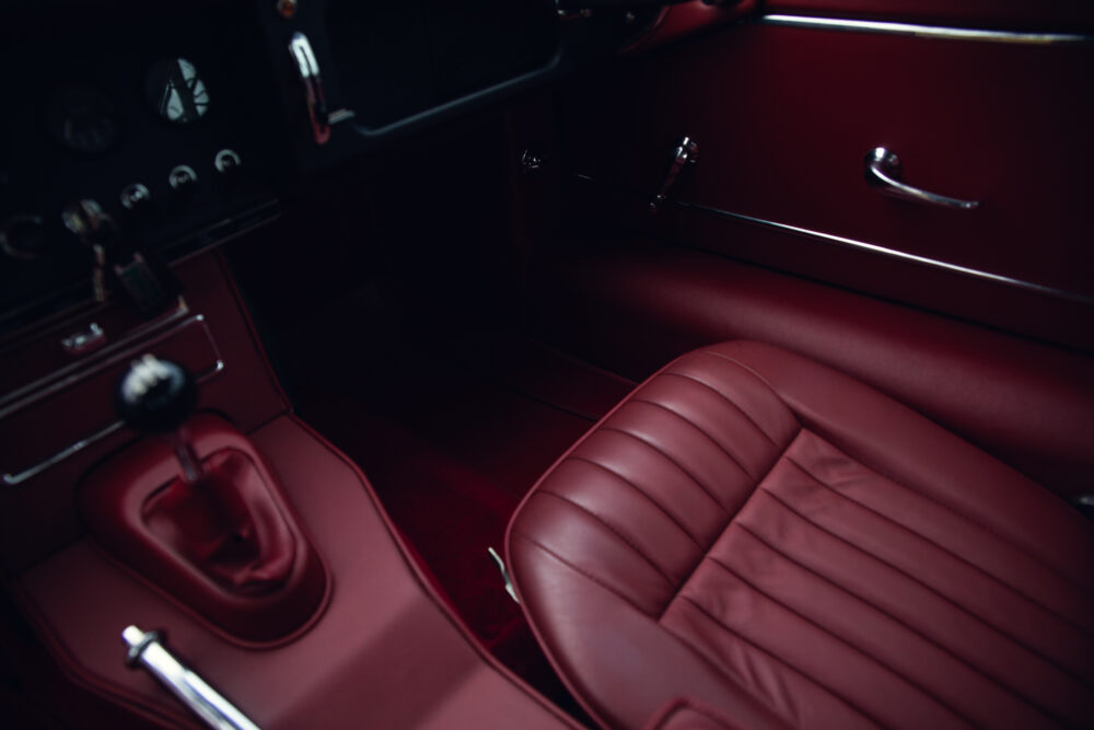 Vintage red car interior, leather seats and dashboard