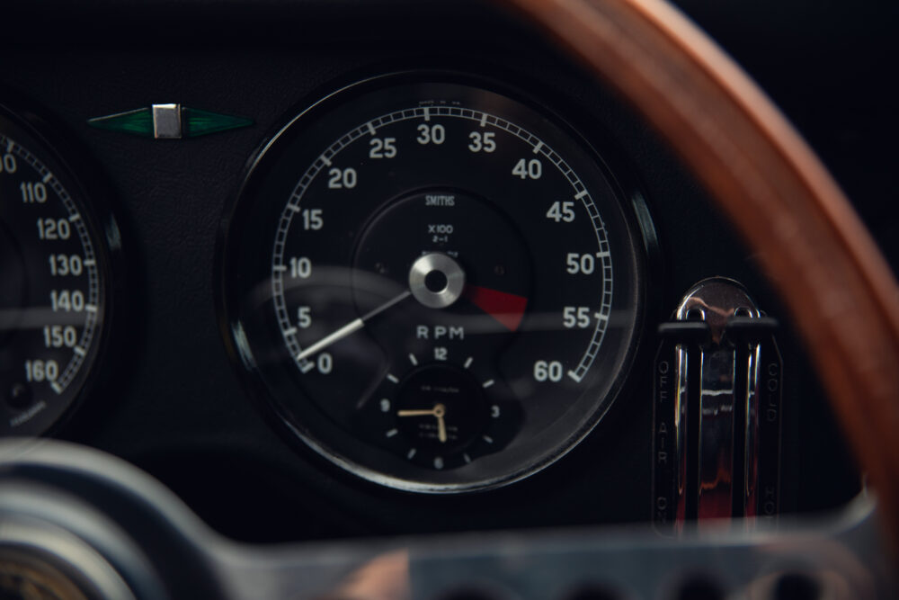 Vintage car dashboard with RPM gauge and wooden accents
