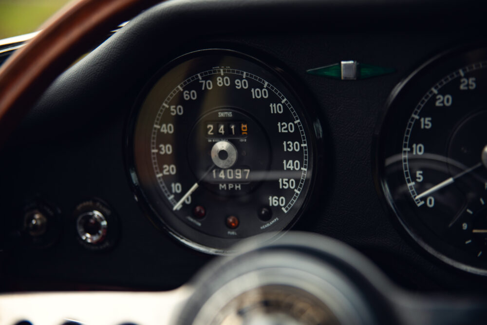 Close-up of classic car speedometer reaching 80 mph