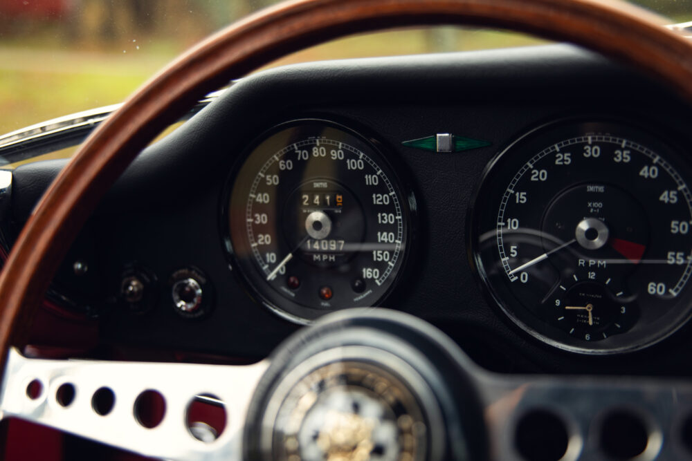 Classic car dashboard with wooden steering wheel