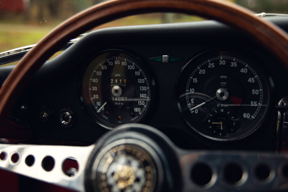 Vintage car dashboard with classic wooden steering wheel