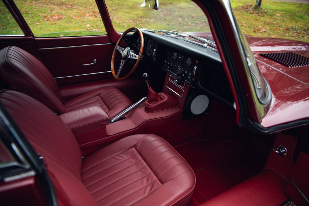 Vintage car interior with red leather seats and dashboard