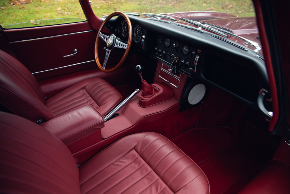 Vintage car interior with red leather seats and dashboard