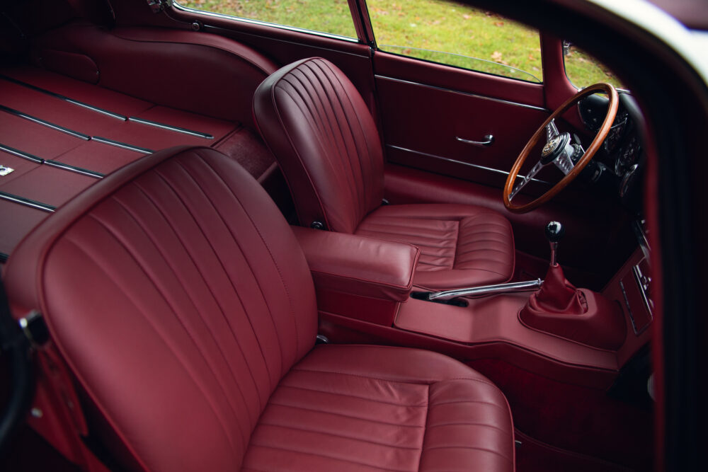 Vintage car luxurious red leather interior with wooden steering