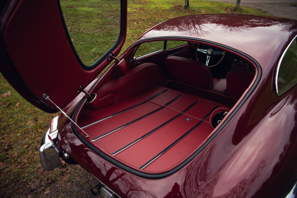 Vintage car trunk opened showing spacious red interior
