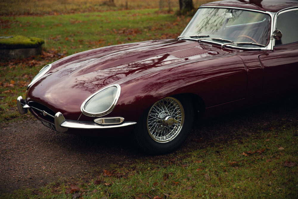 Vintage red Jaguar E-Type car parked outdoors