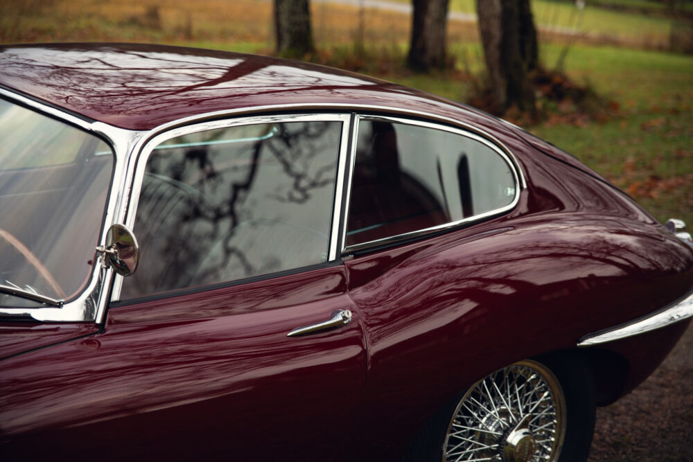 Vintage maroon car with chrome details and wire wheels